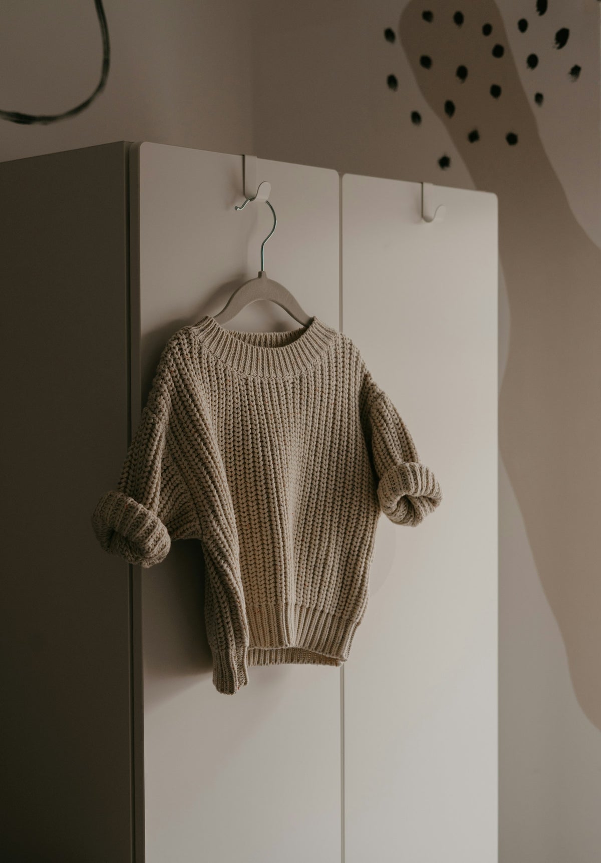 Knitted sweater hanging on a hook