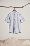 Sky blue linen shirt hanging in daylight