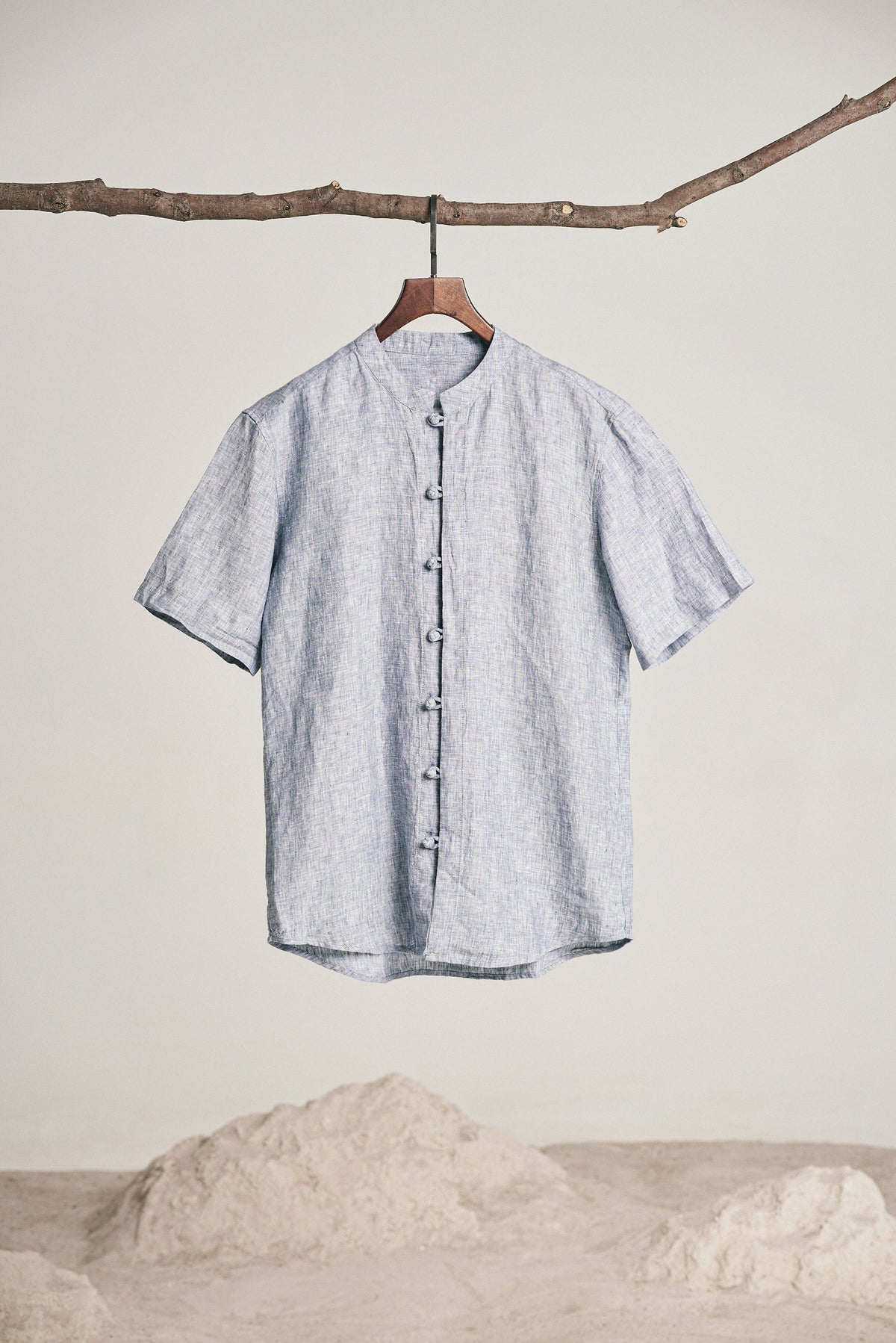 Sky blue linen shirt hanging in daylight